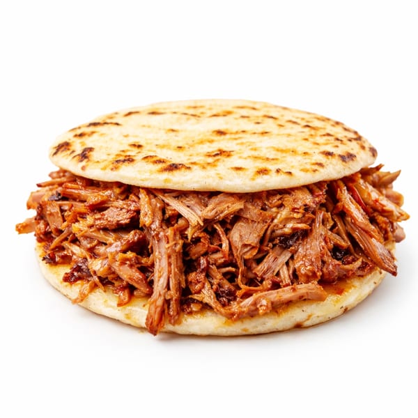 A golden-brown arepa filled with generous amounts of shredded, saucy meat on a white background.